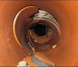 Camera view inside a clay pipe showing a displaced joint